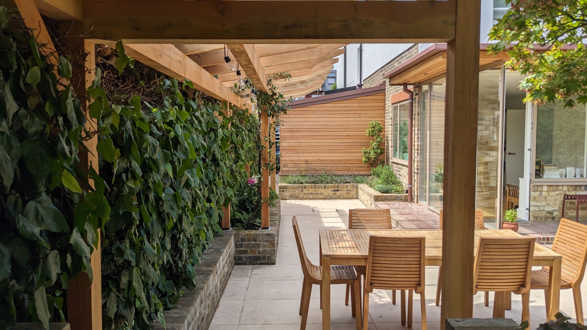 East Dulwich: Rear extension and exposed timber structure to outdoor kitchen, with Tom Wilson Studio